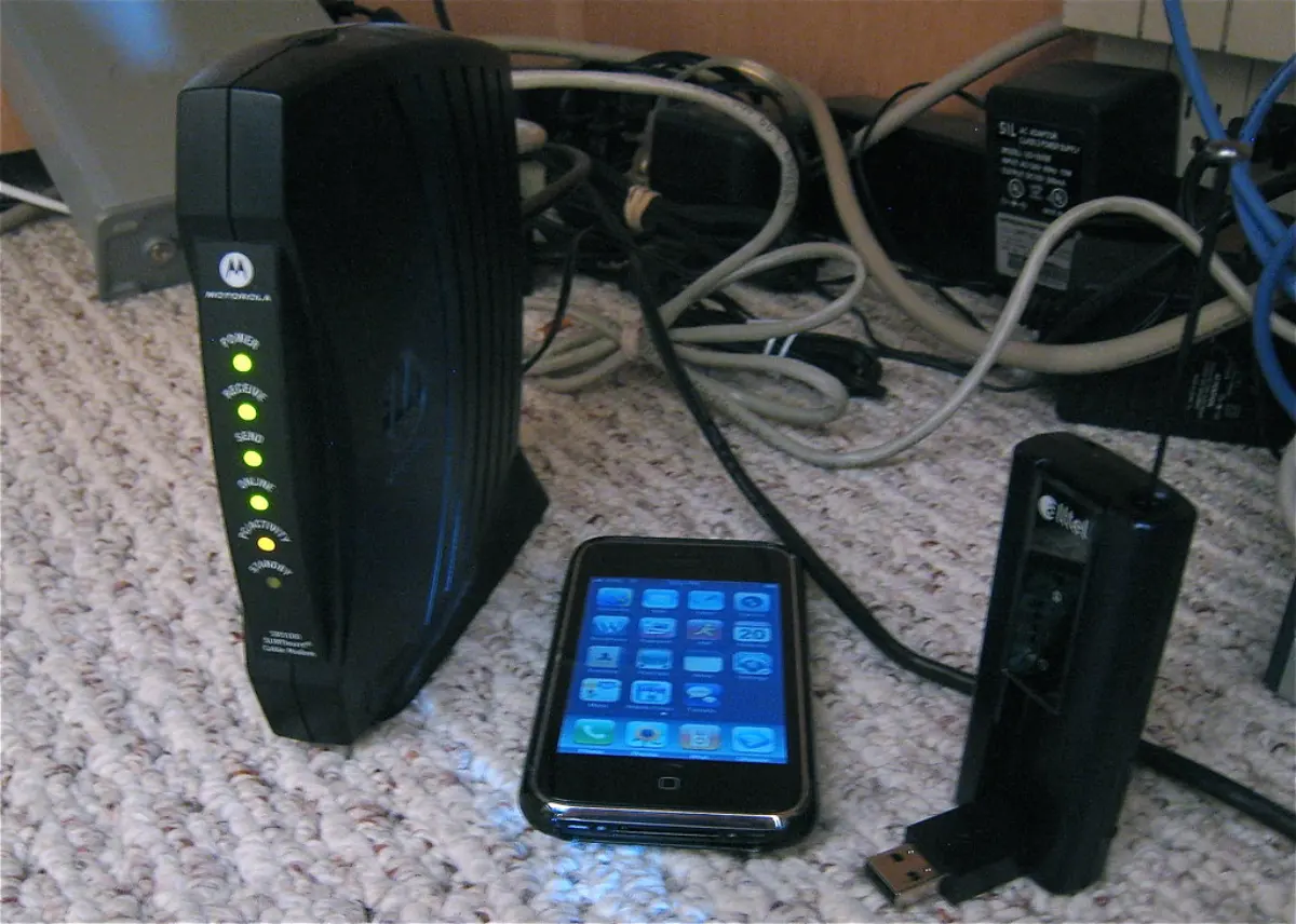 A home broadband modem with cables and a phone